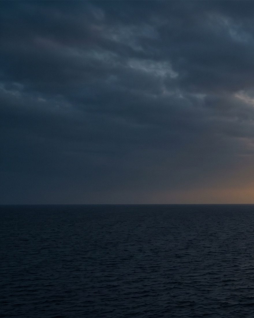 Open sea and horizon under a heavy cloud bank